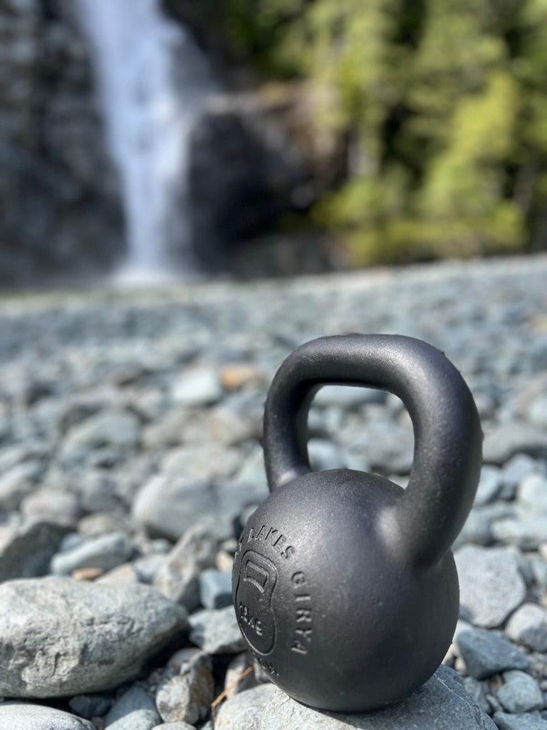 Great Lakes Girya kettlebell photographed beside a waterfall