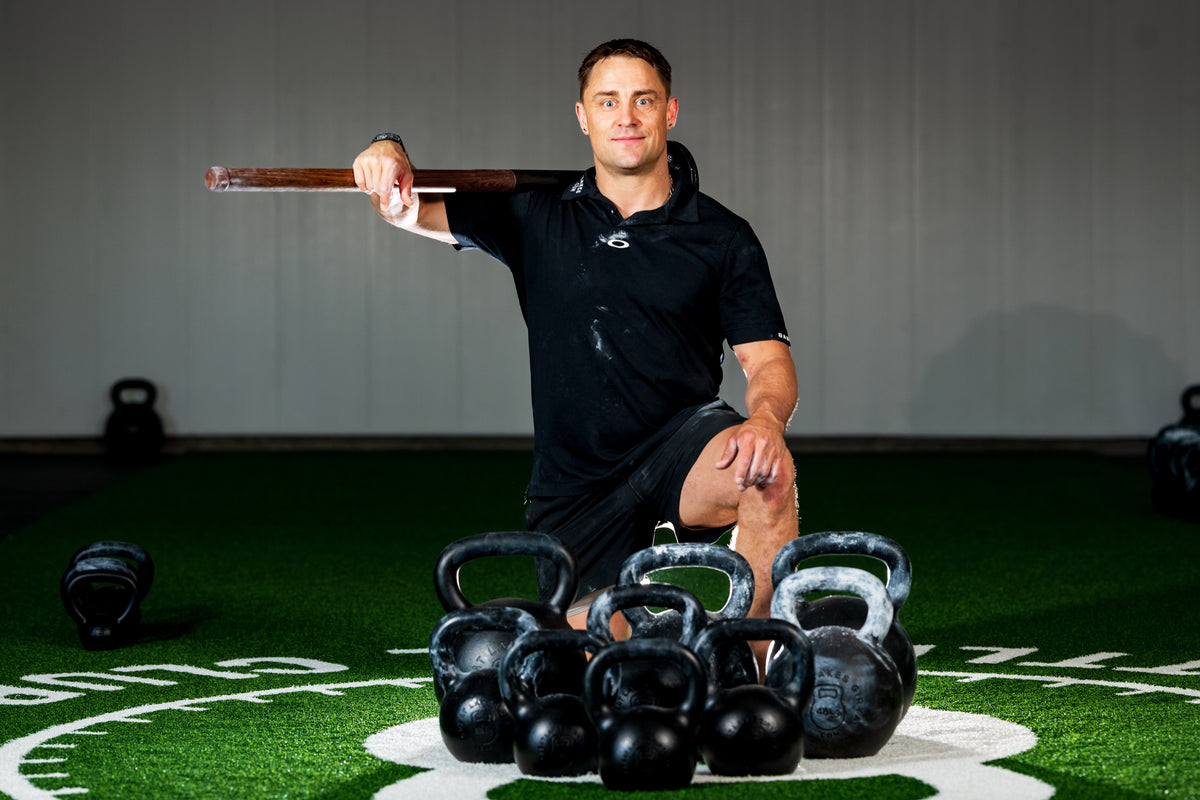 Portrait with a mace and kettlebells on the gym floor
