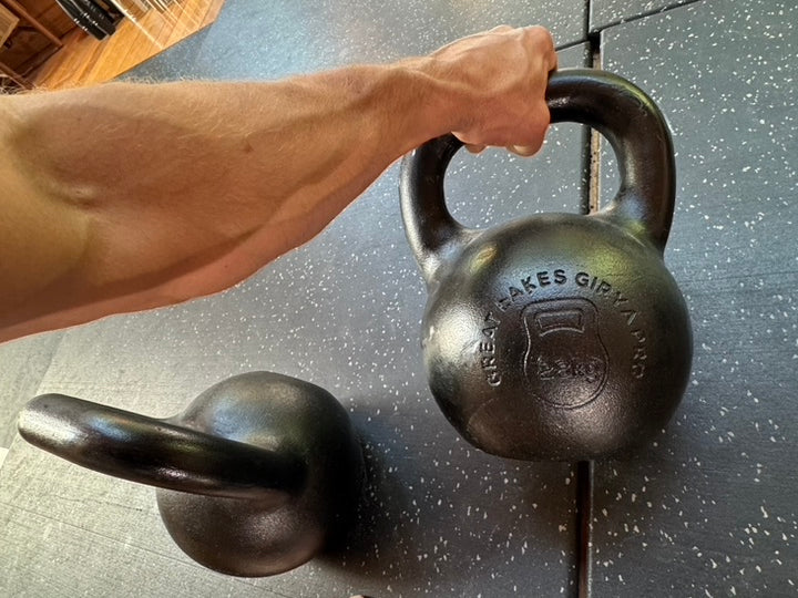 Overhead view of a hand gripping a P-Spec kettlebell