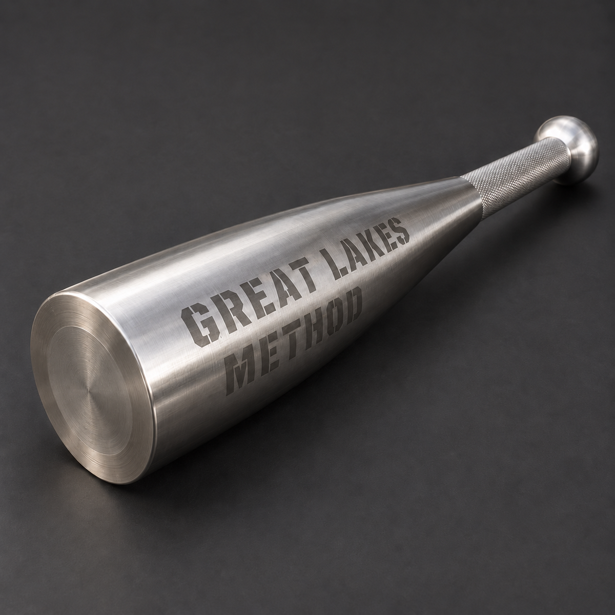 Great Lakes Method stainless steel club with a broad tapered body on a charcoal background