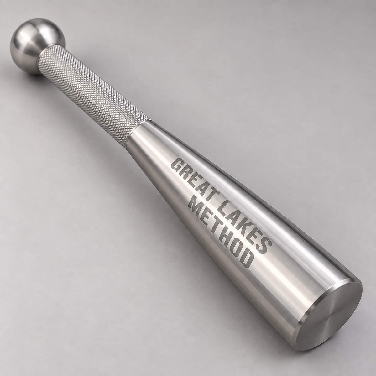 Detail of a Great Lakes Method stainless steel club showing the knurled grip, rounded handle end and stencil branding