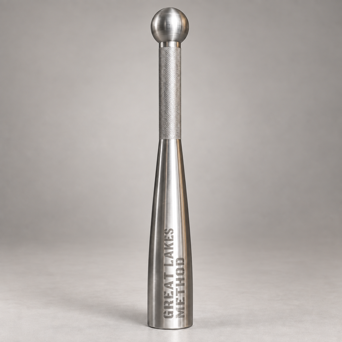 Great Lakes Method 304 stainless steel club standing upright, showing the tapered body and knurled grip